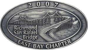 Custom all-metal lapel pin featuring detailed sculpted bridge and mountain artwork in a no‑enamel metal finish, crafted by The Pin Center