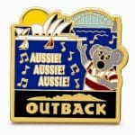 Cartoon koala in a rugby shirt shouting ‘Aussie Aussie Aussie’ with the Sydney Opera House and harbor in the background.