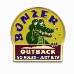 Cartoon crocodile in the ‘Bonzer — No Rules Just Bite’ design, shown with a wide grin and crumbs or bite marks suggesting he just chomped into something.