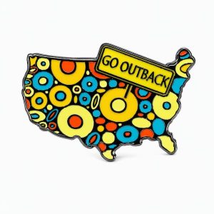 Outback‑themed pin displaying a polka‑dotted cartoon map of the lower 48 states with a bold ‘Go Outback’ sign emerging from the Midwest.