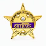 Star shaped lapel pin honoring the Employee of the Month with a rhinestone and Outback logo, with the phrase "The Bloomin' Best" - created by The Pin Center