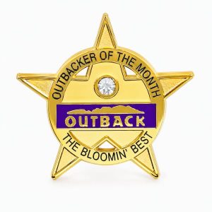 Star shaped lapel pin honoring the Employee of the Month with a rhinestone and Outback logo, with the phrase "The Bloomin' Best" - created by The Pin Center
