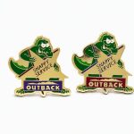 Two lapel pins with slight color variations featuring a croc behind a star with the phrase 'Snappy Service' and the Outback logo, created by The Pin Center