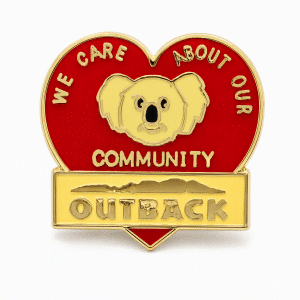Heart shaped lapel pin with a koala saying "we care about our community" and the Outback logo, created by The Pin Center